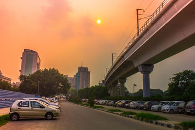 Cars moving on road at sunset