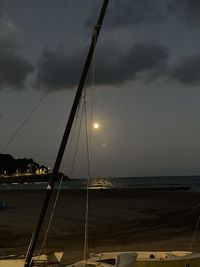 Sailboat in sea against sky during sunset