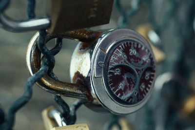 Close-up of combination padlock on fence