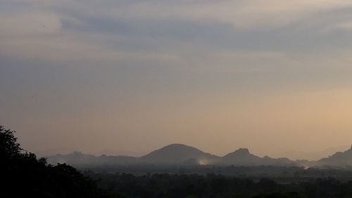 Scenic view of silhouette mountains against sky during sunset