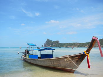 Longtail boat on shore at phi phi islands