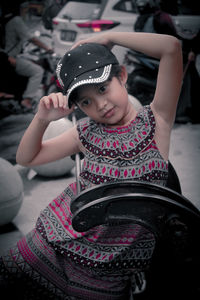 Portrait of cute girl sitting outdoors