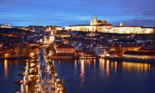 Illuminated buildings in city at dusk