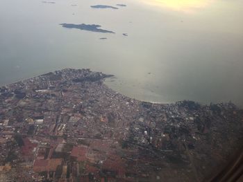 High angle view of buildings and sea in town