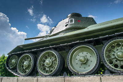 Low angle view of armored tank against sky