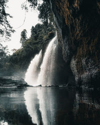 Scenic view of waterfall against sky