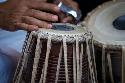 Midsection of man playing tabla