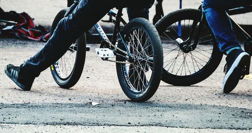 Low section of people riding bicycle on street