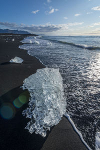 Ice formations on beach during sunrise, vestmannaeyjar, iceland, southern region