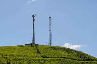 Mobile cell tower in open field with blue sky in countryside