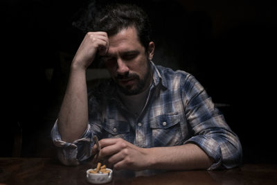 Portrait of man with ice cream on table