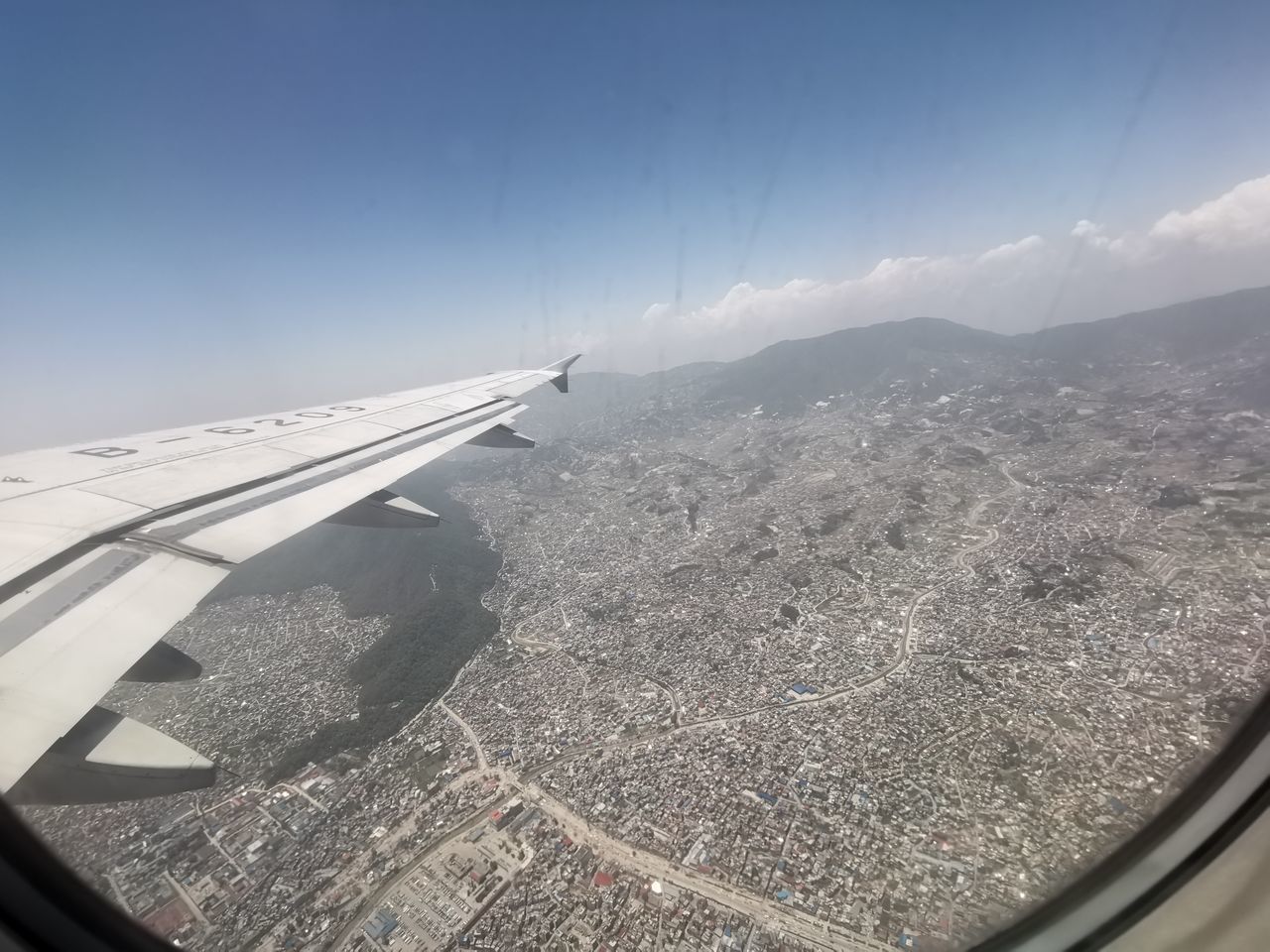 AERIAL VIEW OF MOUNTAINS AND AIRPLANE