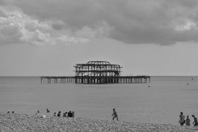 People on beach against sky