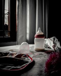 Table and chairs on bed by window