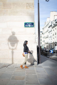 Woman with camera walking on fotpath