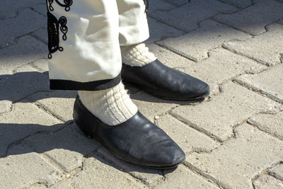 Low section of man standing on footpath