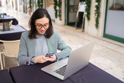 Young woman using laptop at home