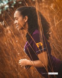 Portrait of young woman on field