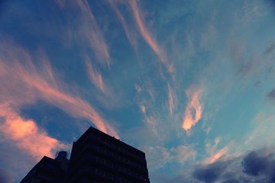 Low angle view of building against cloudy sky