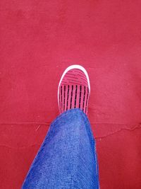 Low section of woman standing on red carpet