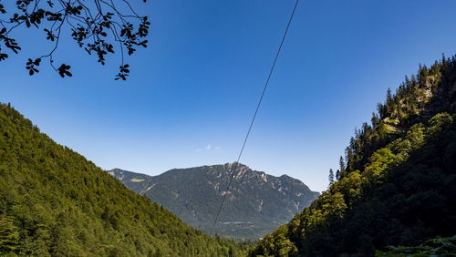 Scenic view of mountains against clear blue sky