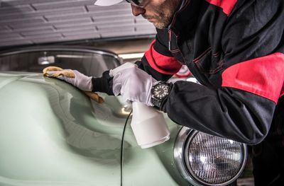 Man cleaning car in garage