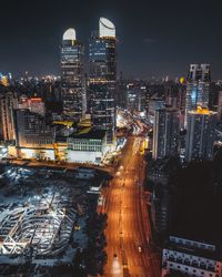 High angle view of illuminated buildings in city at night