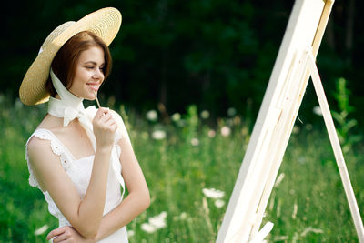 Portrait of young woman in hat