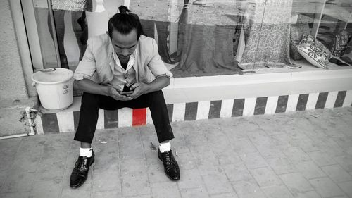 Full length of woman sitting on chair