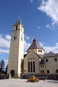 Low angle view of church and building against sky
