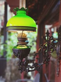 Close-up of illuminated lamp hanging on street