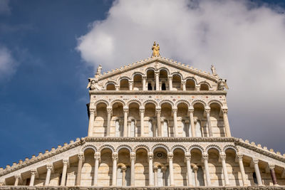 Low angle view of building against cloudy sky