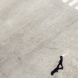 High angle view of man walking on street