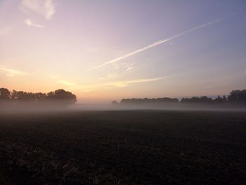 Scenic view of field against sky during sunset