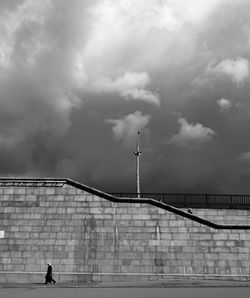 Man walking on staircase against wall