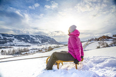 Man on snowcapped mountain against sky