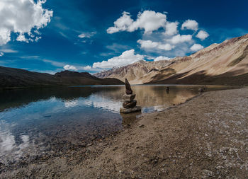 Scenic view of lake and mountains against sky