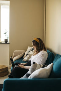Woman on sofa using laptop