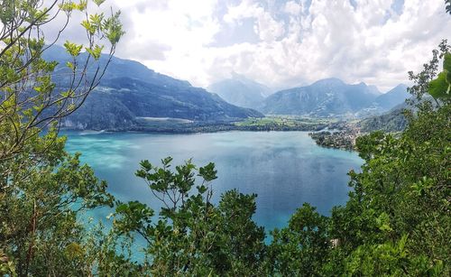 Scenic view of lake and mountains against sky