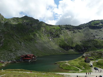 Scenic view of lake and mountains against sky