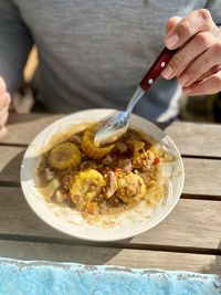 Close-up of hand holding food on table