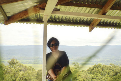 Portrait of young man wearing sunglasses standing on land