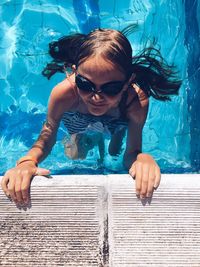 Portrait of young woman swimming in pool