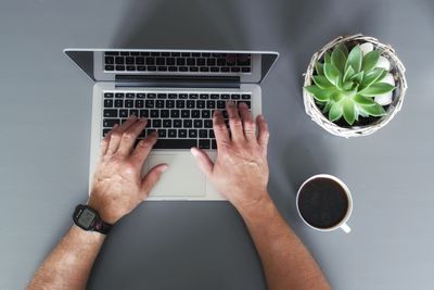 Directly above view of man using laptop on table