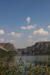 Scenic view of lake and mountains against sky