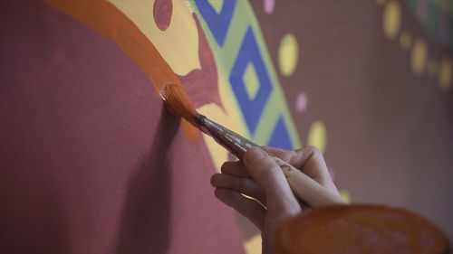 Cropped hand of woman drawing on table