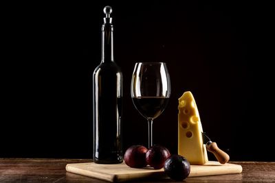 Wine glasses on table against black background