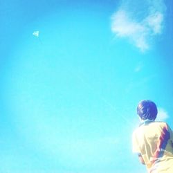 Low angle view of people against blue sky