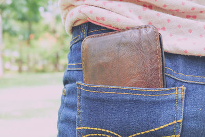 Close-up of wallet in pocket of person 