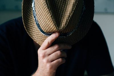 Close-up of man hand holding hat